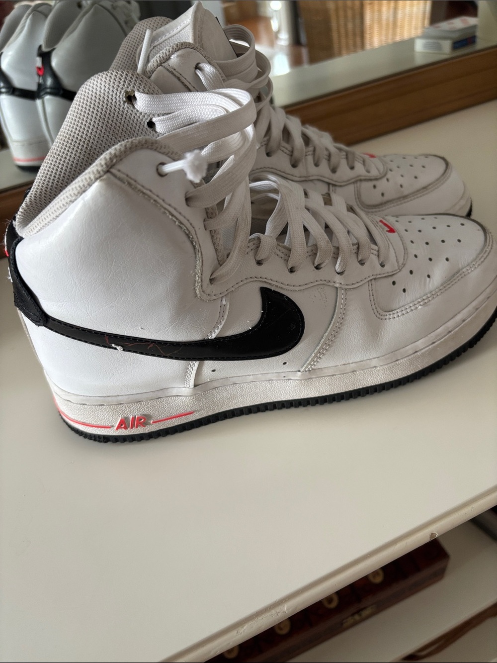 Nike White High-Top Sneakers with Black Swoosh and Red Accents